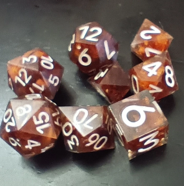 Resin dice with inserts made from cherry wood shavings.